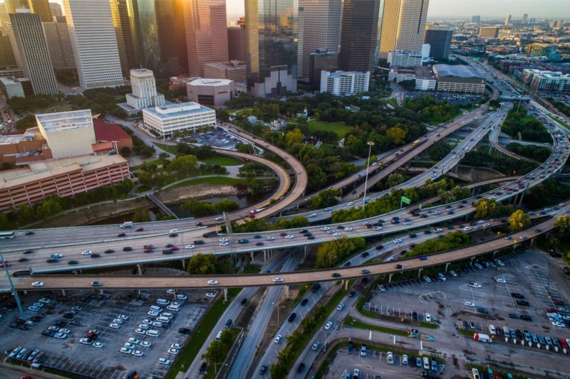 Aerial view of a highway with a bridge and lots of cars