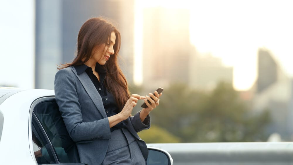 female insurance agent using smartphone for social media marketing