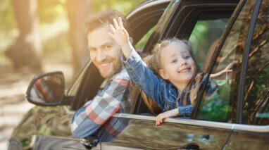 happy father and daughter in car