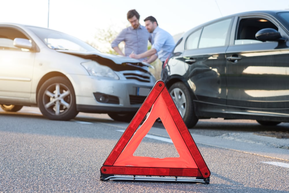 Two men reporting a car crash for the insurance claim