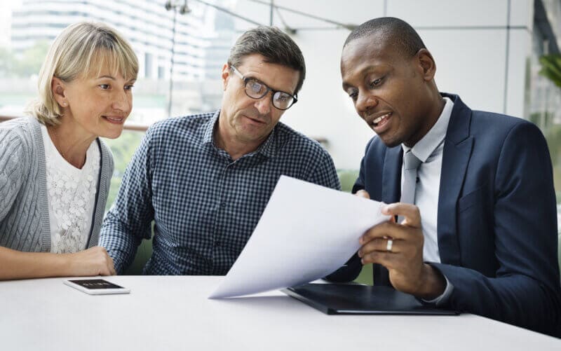 insurance agent explaining policy to customers