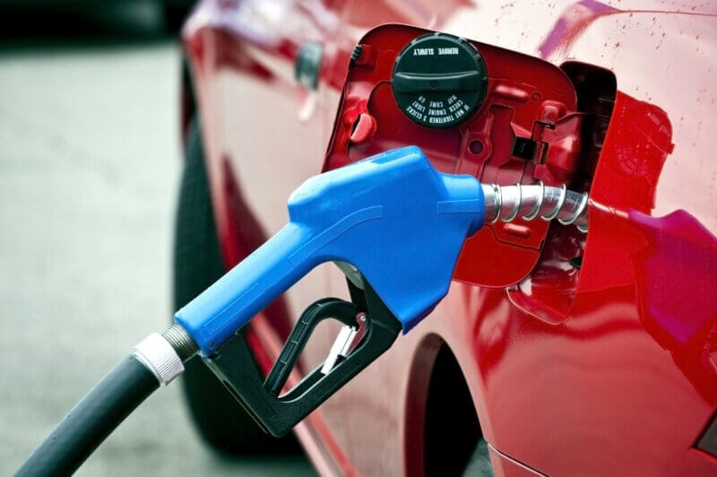 blue gas nozzle in red car