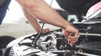 hood of vehicle open with mechanic arm