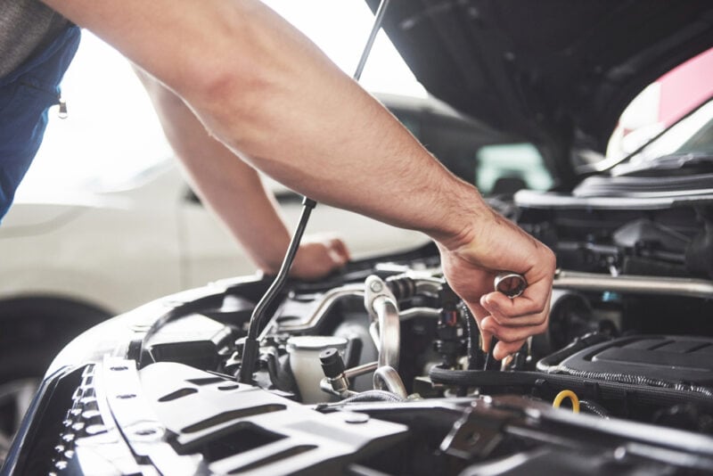 hood of vehicle open with mechanic arm