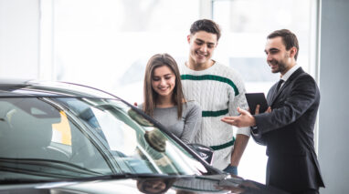 couple looking at new car