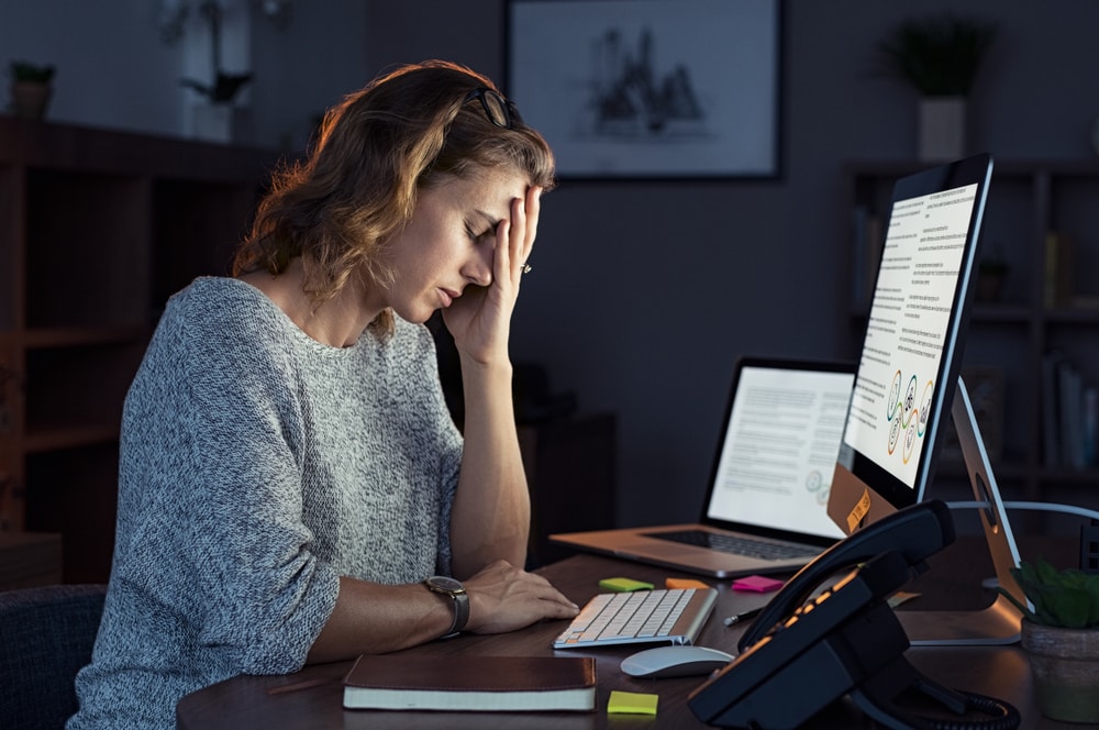 insurance agent working at night in front of computer 