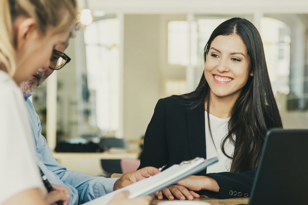 female insurance agent smiling helping clients