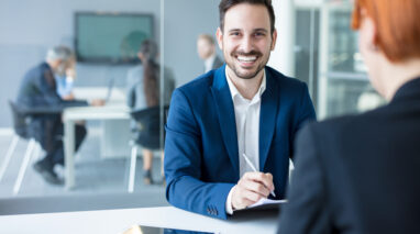 male insurance agent in office smiling