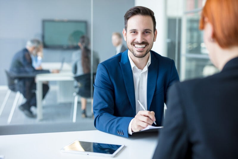 male insurance agent in office smiling