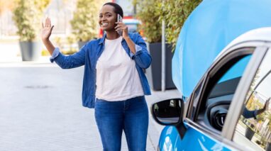Cheerful African American woman calls roadside assistance