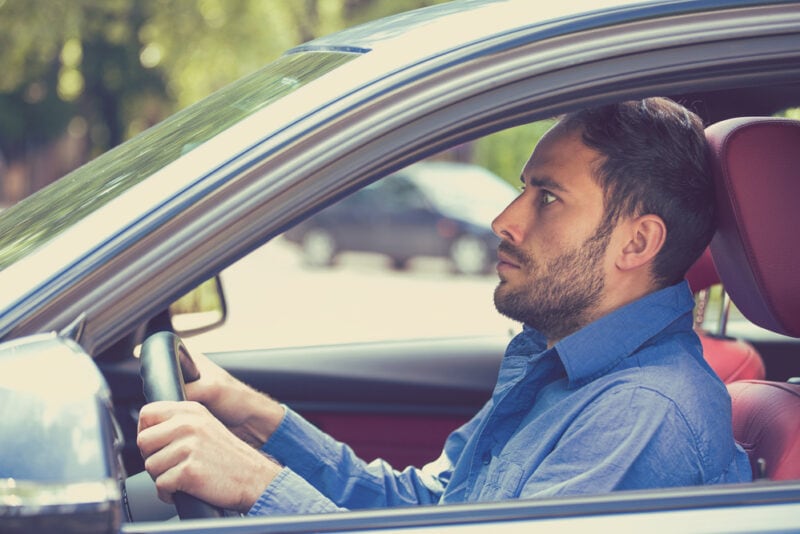 Man looks anxious behind the wheel