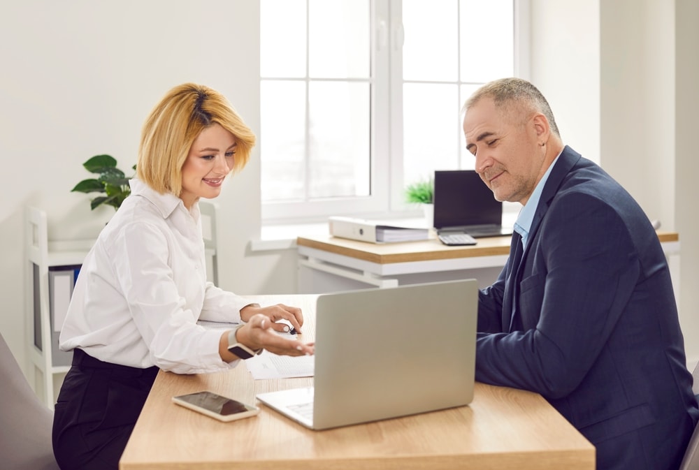 Female insurance agent shows male client his options