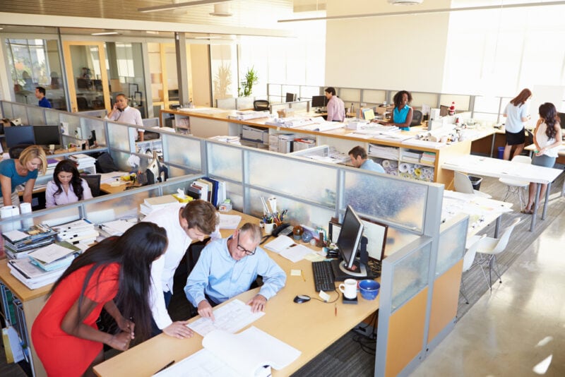 View from above of a happy bustling office space with workers