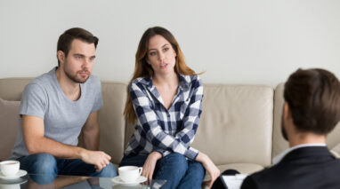Stressed millennial couple talking to insurance agent about high prices - independent insurance agent car insurance